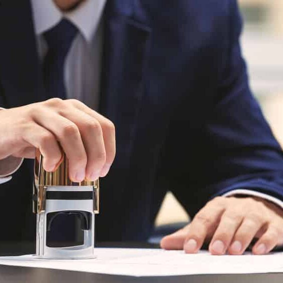 Notary public in office stamping document Notary public in office stamping document